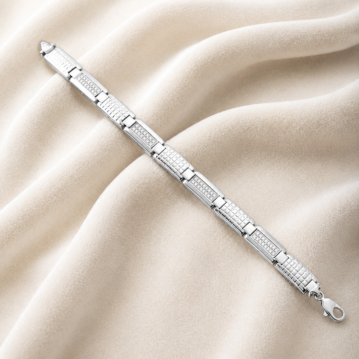 Close-up of the polished metallic finish and articulated joints on a textured grid link sterling silver bracelet