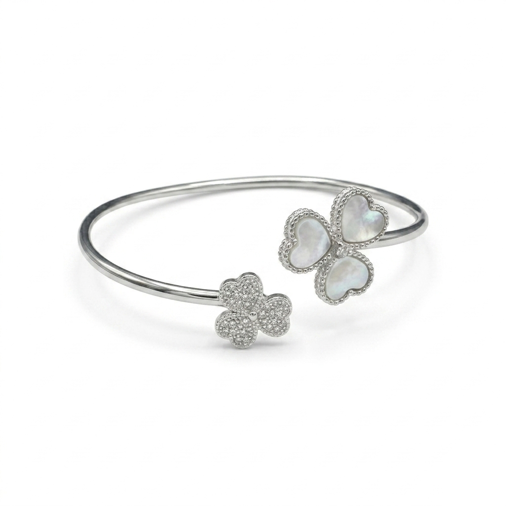 Close-up studio shot of the Triple Heart Open Kada on a white background highlighting its asymmetrical clover design.