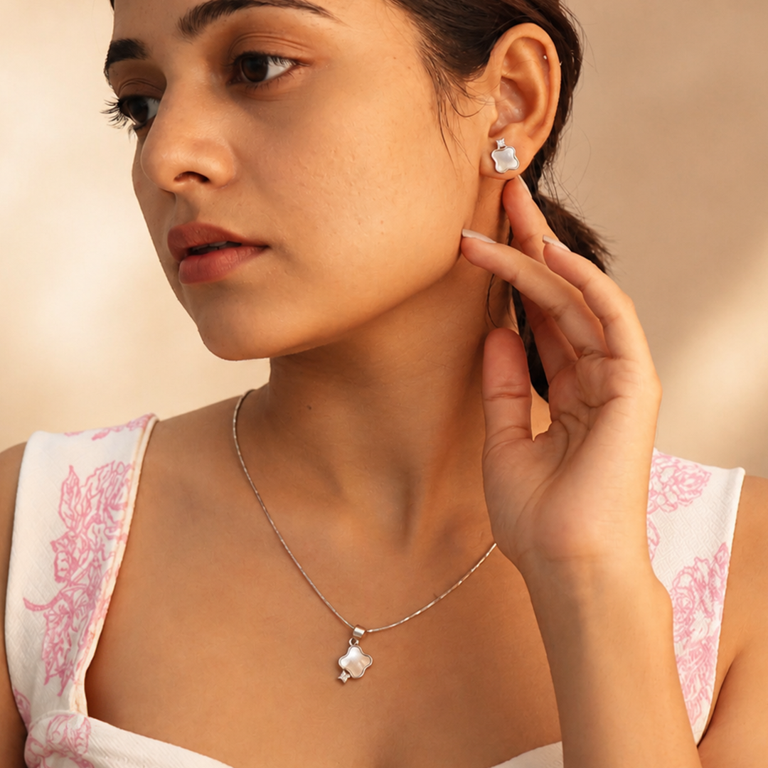 Front view of the mother of pearl silver clover set with cubic zirconia detailing at the base