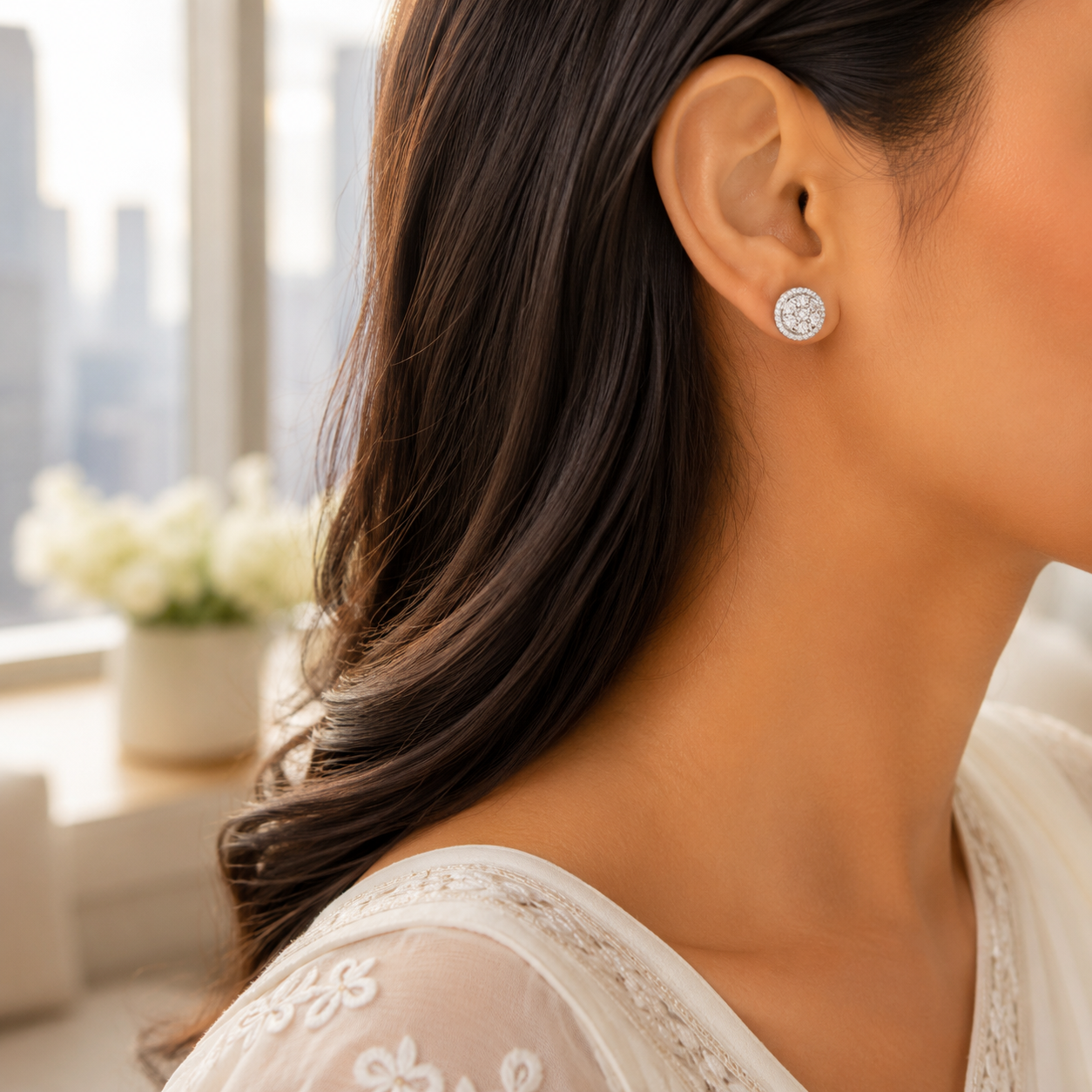 Close-up of a woman wearing the Brilliant Round Halo Silver Stud Earrings, showcasing its elegant size on the earlobe