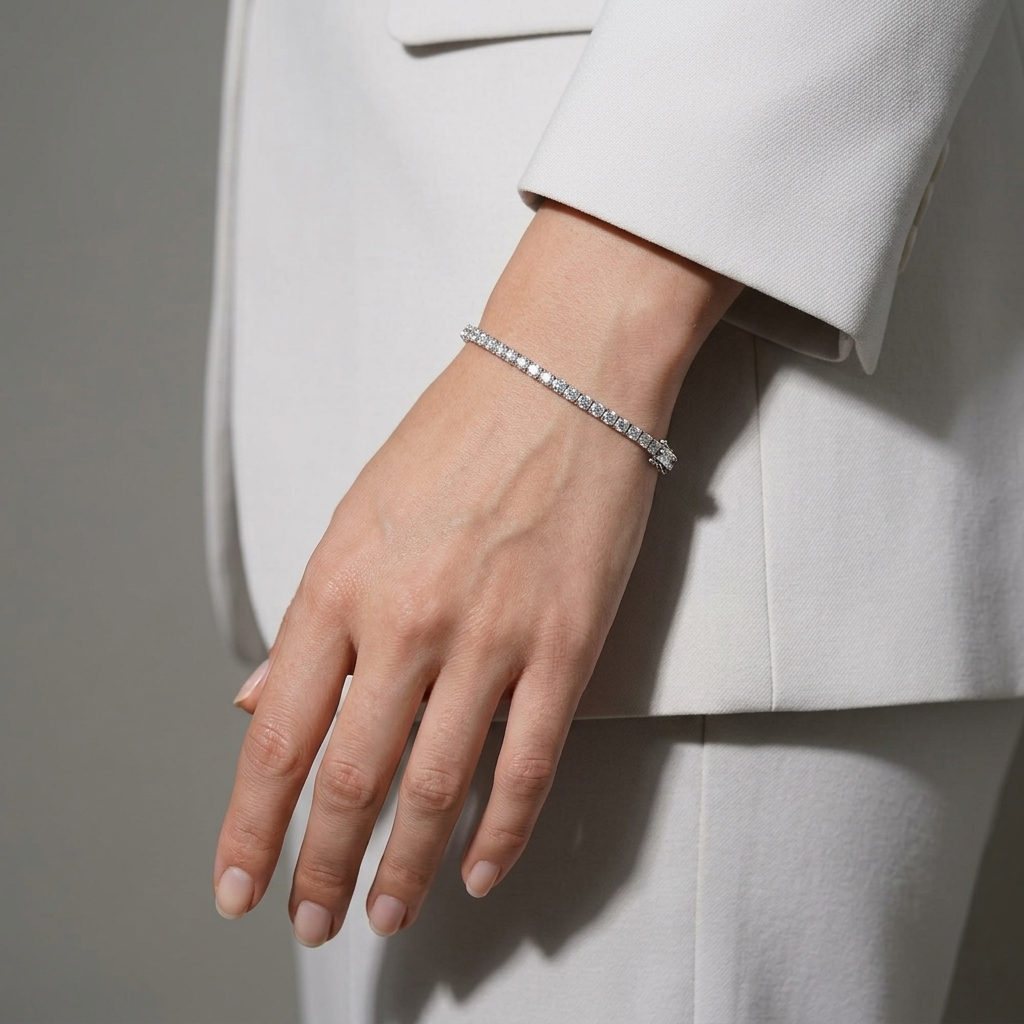 Model wearing the Classic Diamond Tennis Silver Bracelet alongside a white tailored blazer, showcasing its elegant styling for daytime or professional wear.