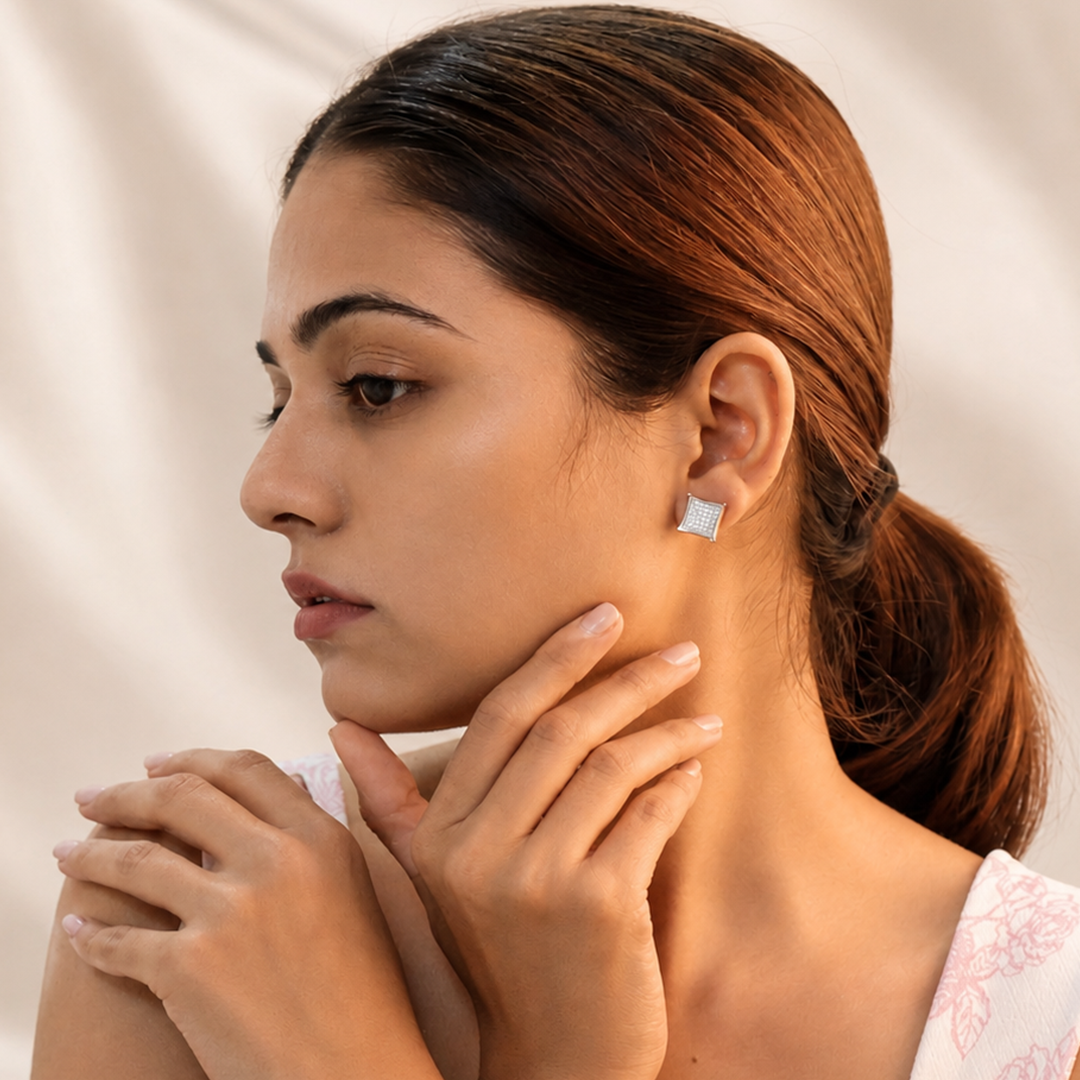 Close-up portrait of an elegant woman modeling the Concave Square Pave Silver Stud Earrings