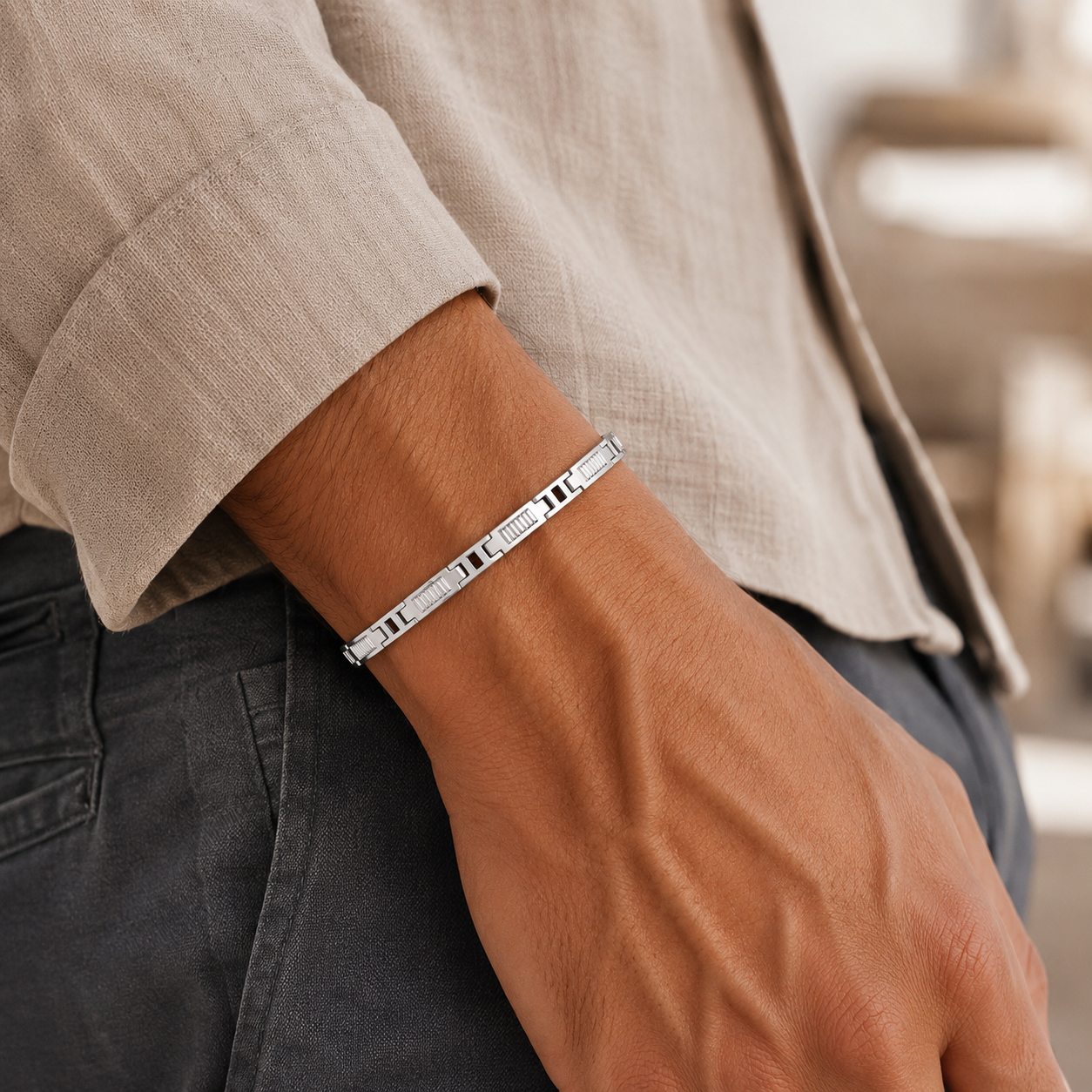 Close-up of the lobster clasp and textured rectangular links on the silver men's bracelet