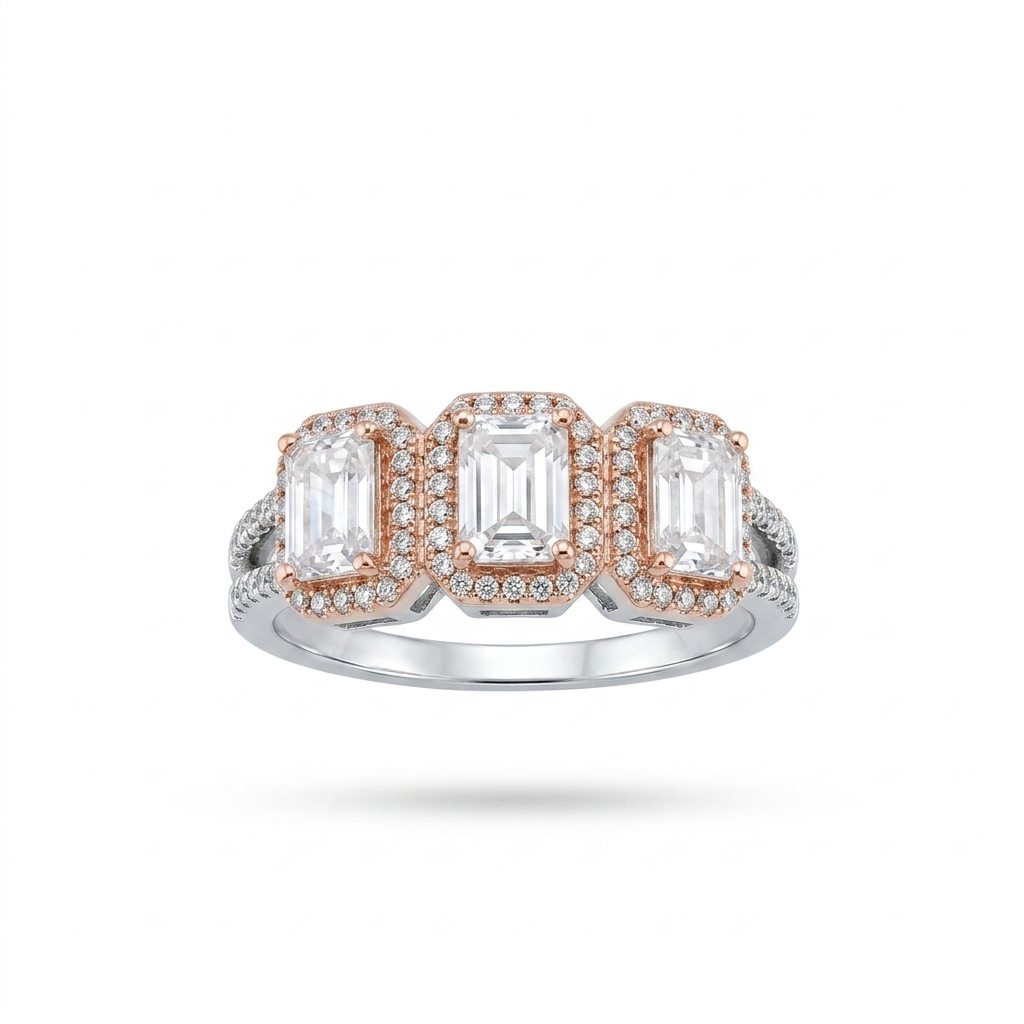 Close-up studio shot of the Emerald Cut Three-Stone Halo Ring featuring three emerald-cut stones with sparkling halos.