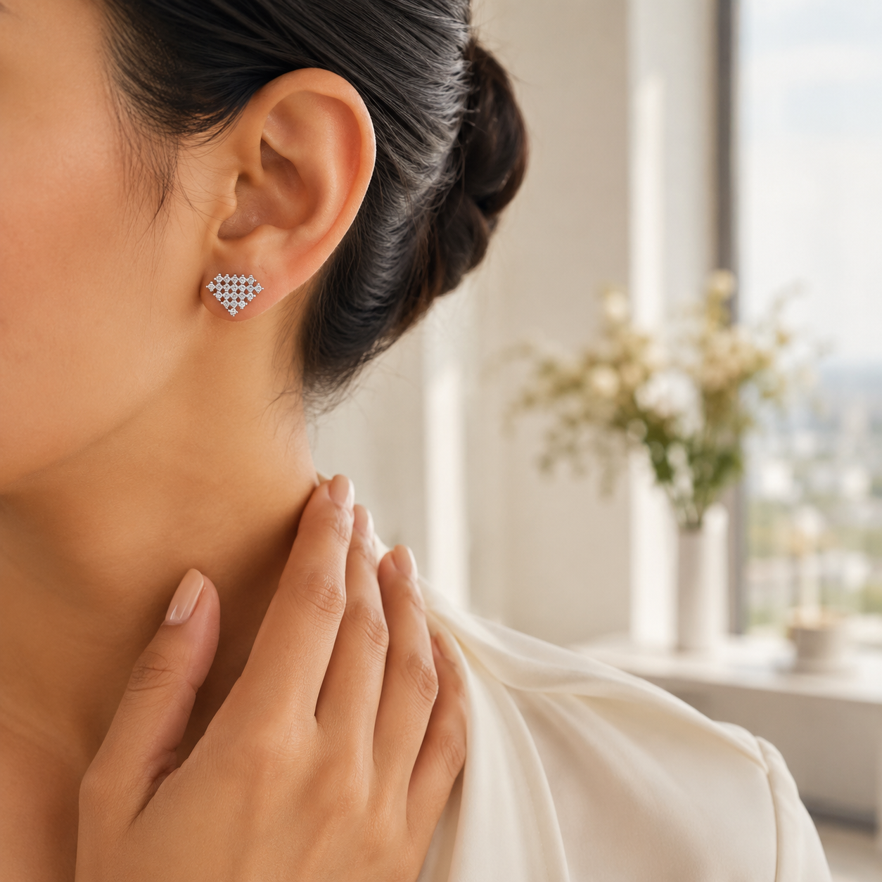 Side profile of a woman wearing the sparkling Geometric Diamond-Shaped Silver Crystal Stud Earrings.