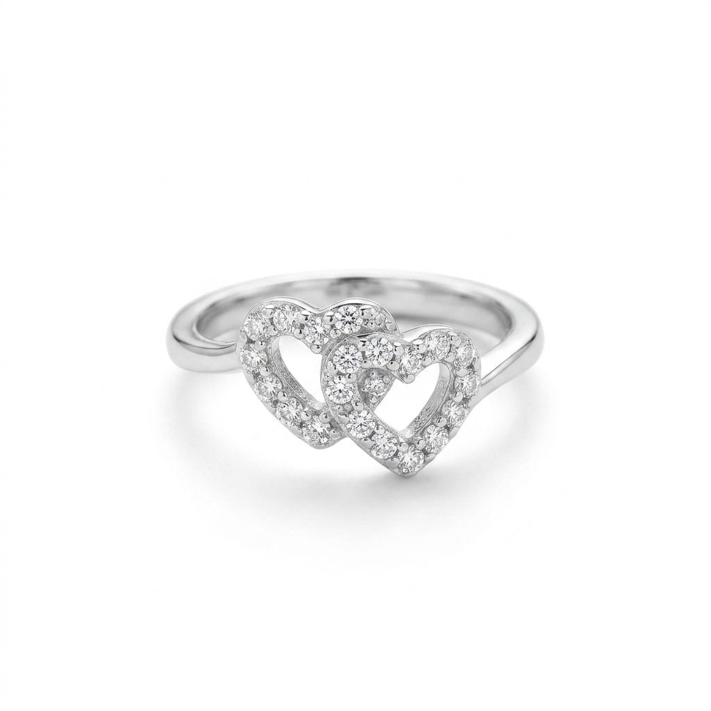 Close-up studio shot of an Interlocking Double Heart Silver Ring featuring two connected hearts covered in clear stones on a white background