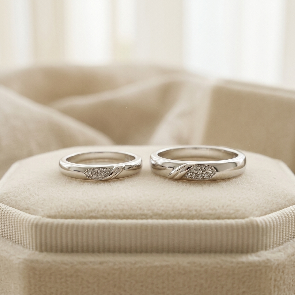 Matching Silver Pave Leaf Couple Bands resting beautifully on a soft beige velvet jewellery display cushion