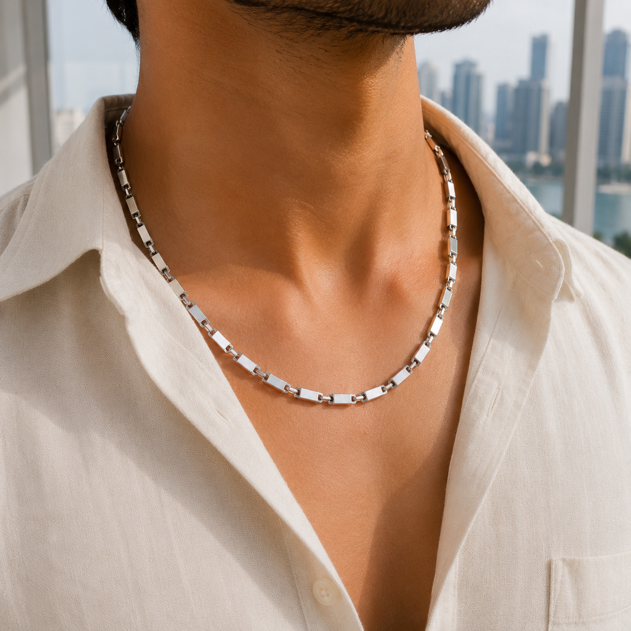 Male model wearing the Men's Silver Textured Bar Link Chain outdoors with a white collared shirt.