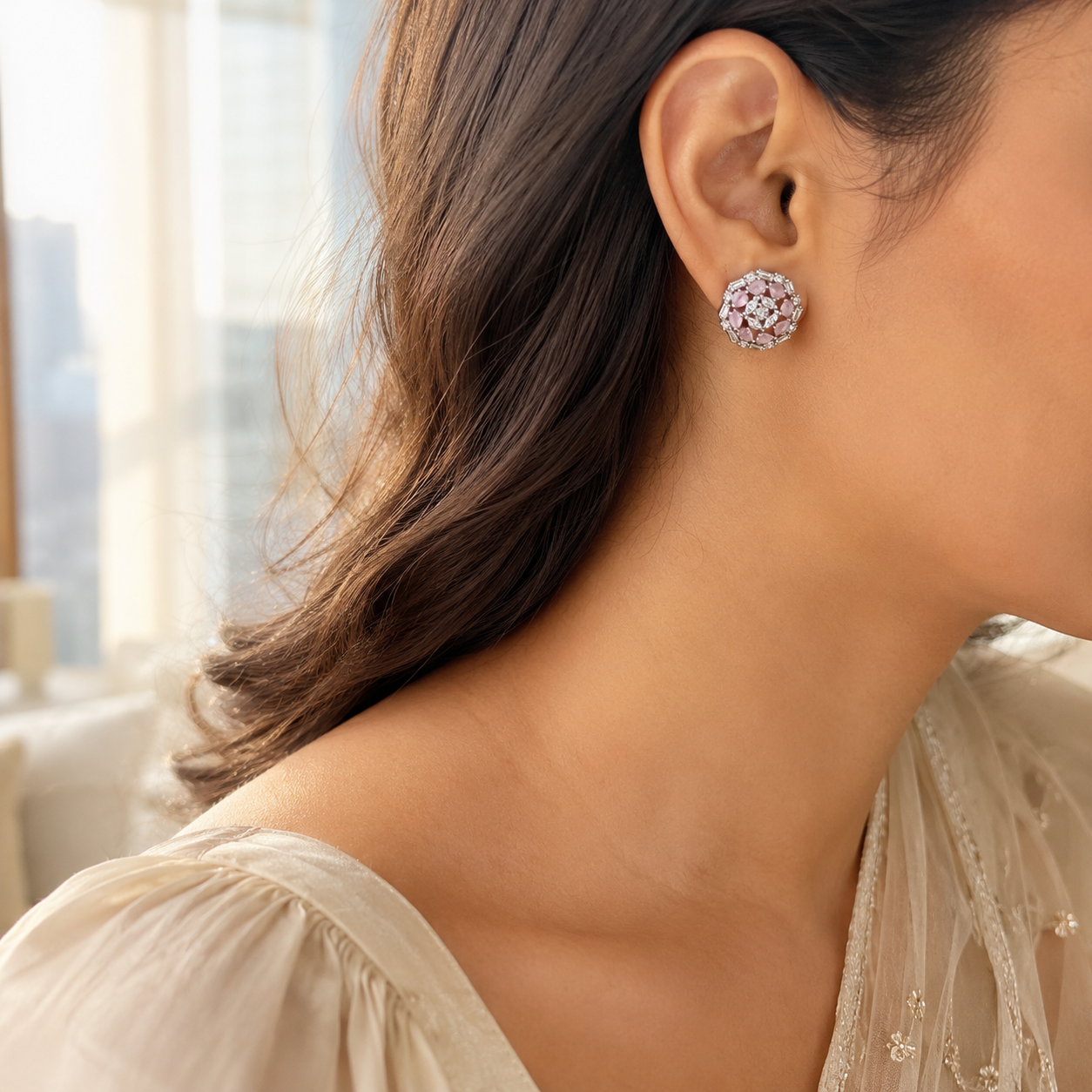 Close-up profile of a woman with dark wavy hair wearing the oversized Pink Stone Floral Silver Cluster Stud Earrings