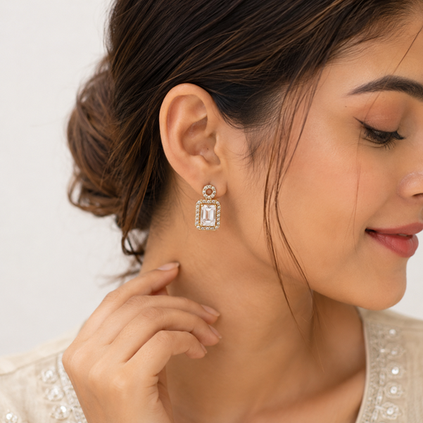 Model wearing Rose Gold Round Halo Emerald Cut Drop Earrings with a sparkling emerald-cut drop design