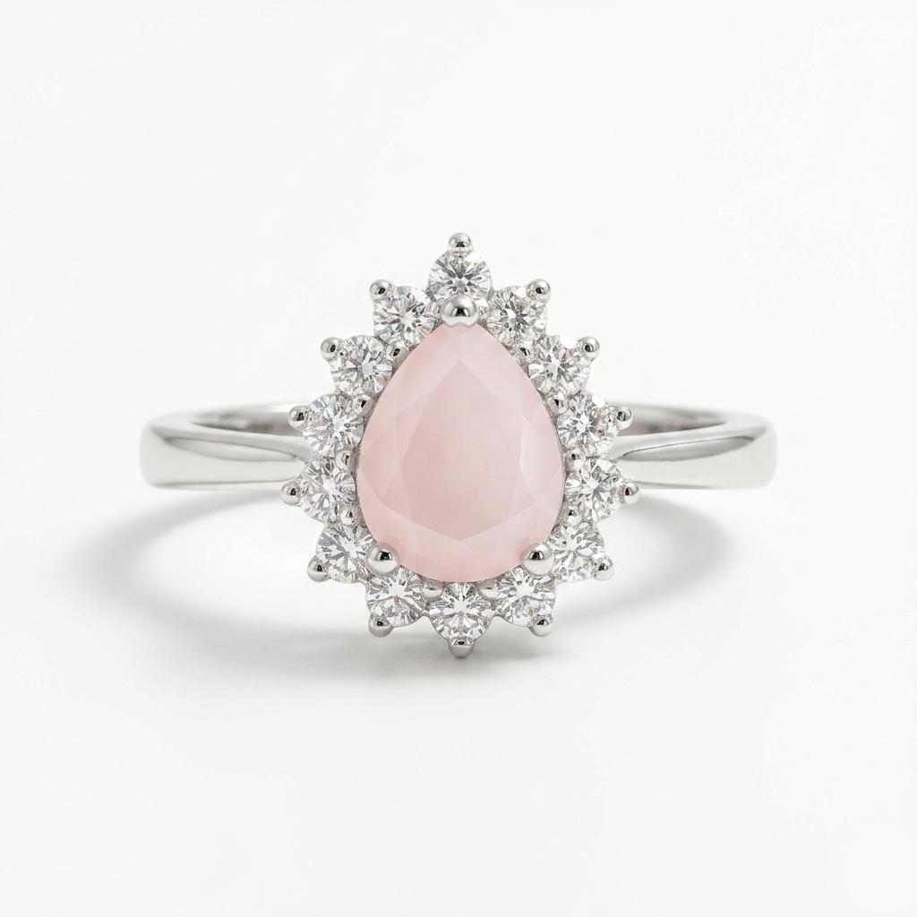 Close-up of the Rose Quartz Pear Halo Silver Ring showcasing the teardrop pink center stone and clear crystal halo on a white background