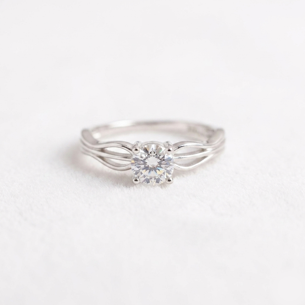Close-up of a Round-Cut Silver Solitaire Wave Ring on a soft white background showing the split shank design