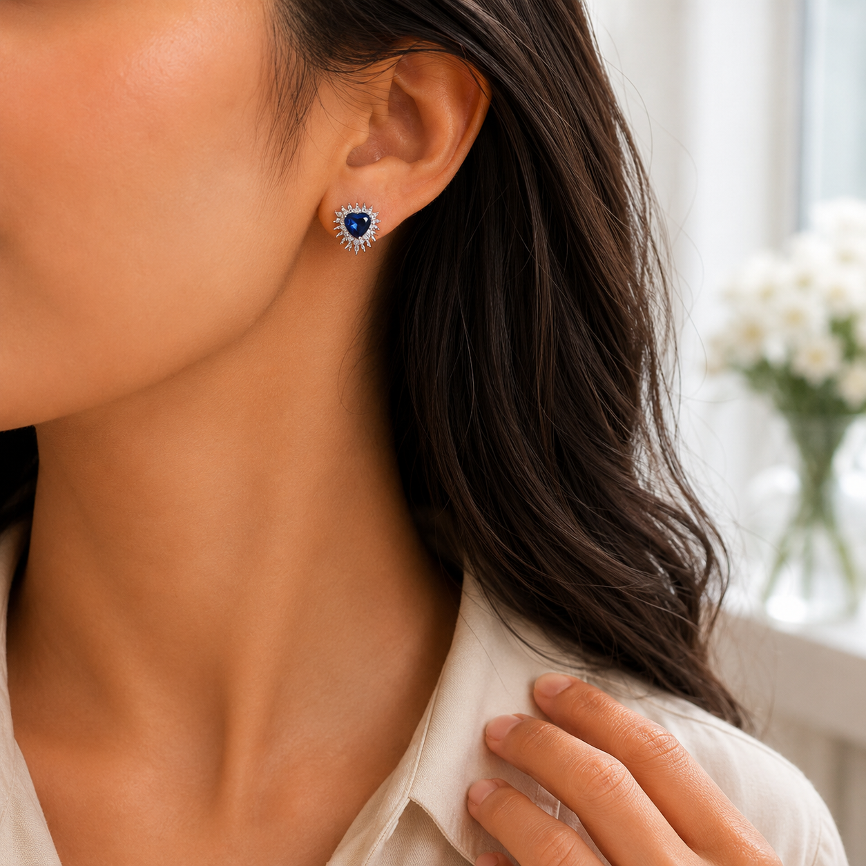 Side profile of a woman wearing the Royal Blue Heart Sunburst Halo Stud Earrings to show scale and fit