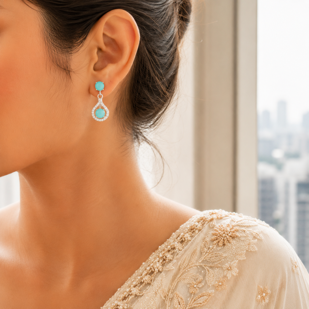 Woman wearing Sea Green Teardrop Halo Drop Earrings with a round stud top and teardrop halo drop paired with an embellished beige traditional outfit.