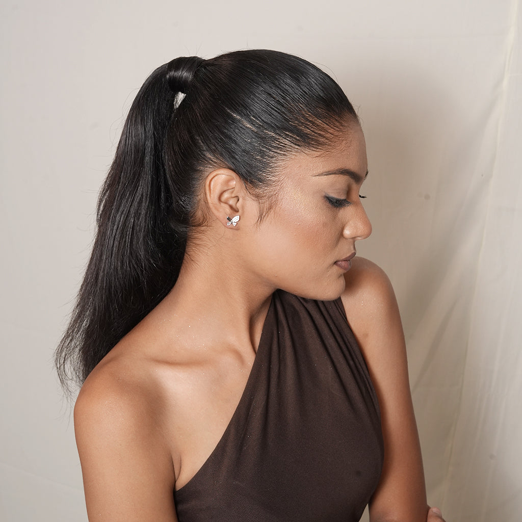 Model wearing Silver Asymmetric Pave Butterfly Stud Earrings