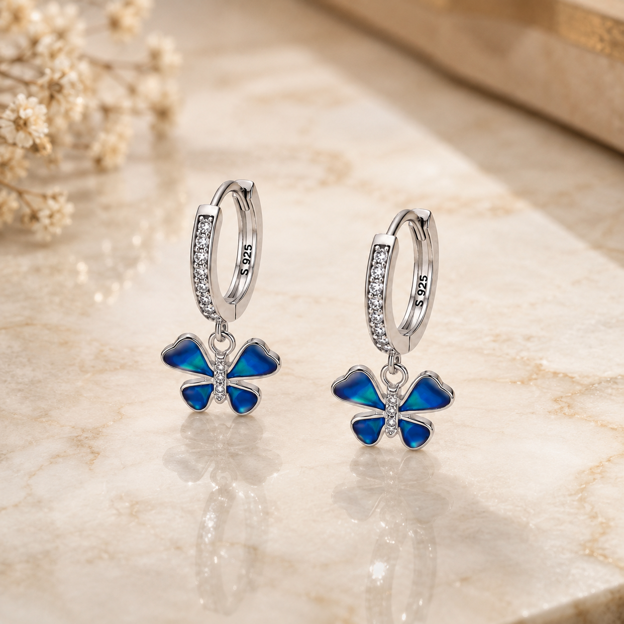 Silver Blue Enamel CZ Butterfly Huggie Drop Earrings with blue enamel wings, CZ-set butterfly bodies and sparkling huggie hoops