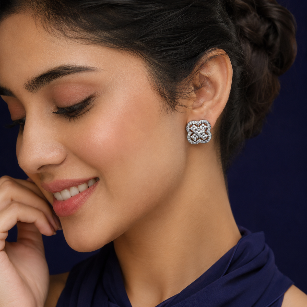 Model wearing Silver Clover Stud Earrings (Princess Cut CZ) with a structured four-lobed clover design