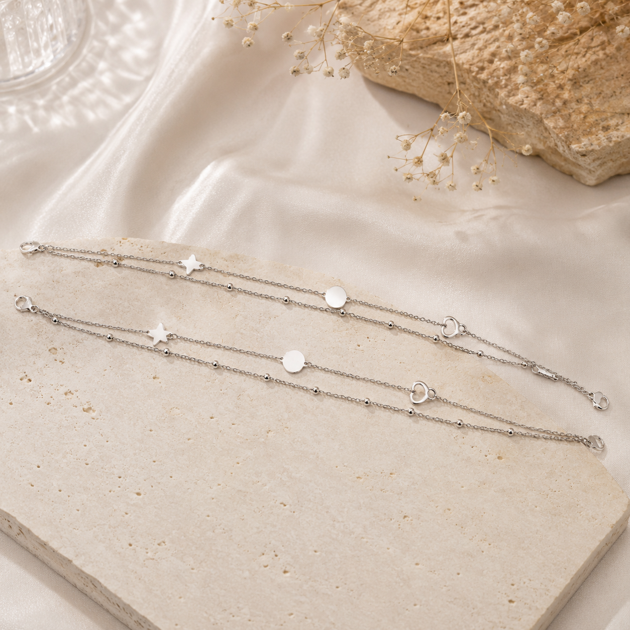 Flat discs and pave hearts on a silver anklet
