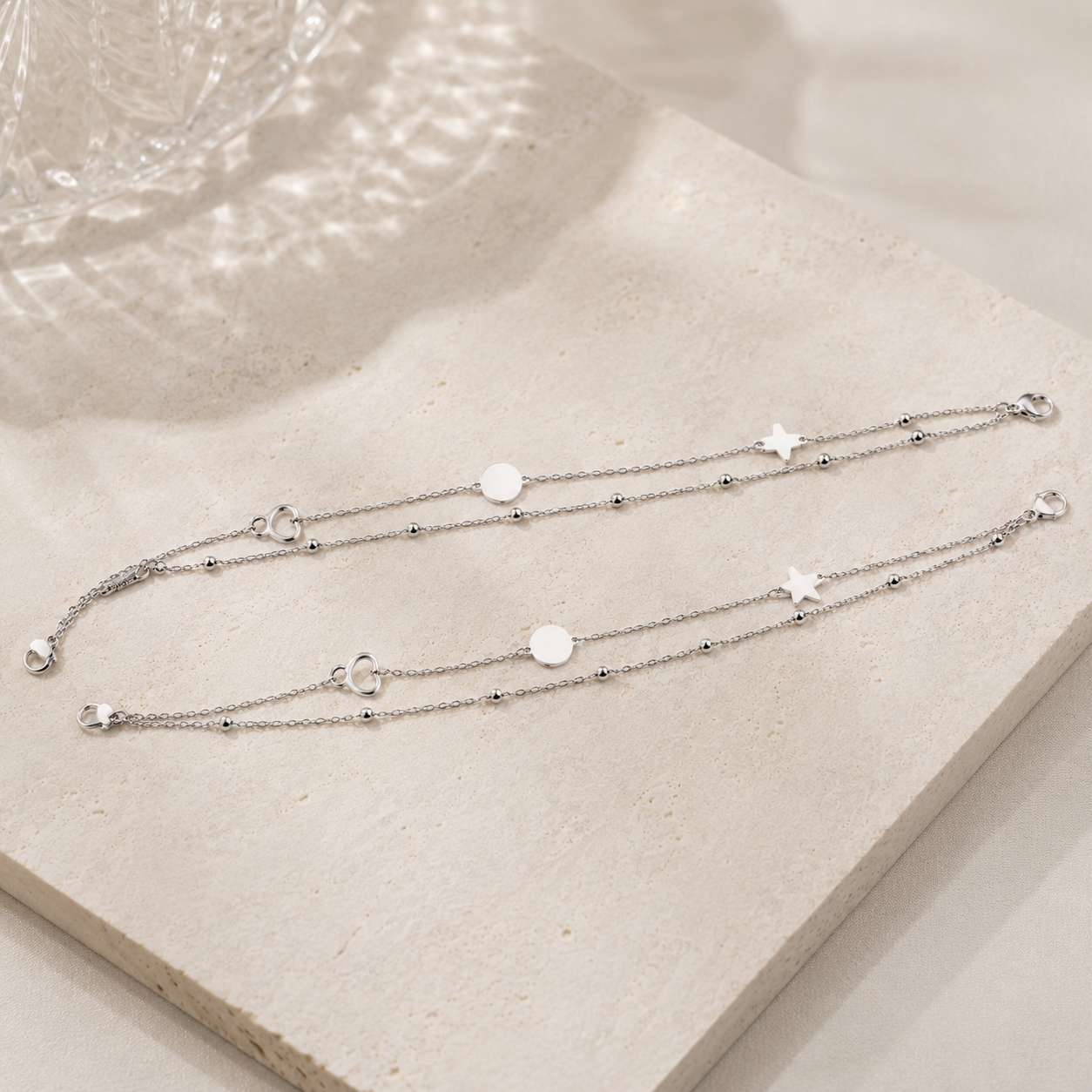 Adjustable silver anklet with alternating disc and heart motifs