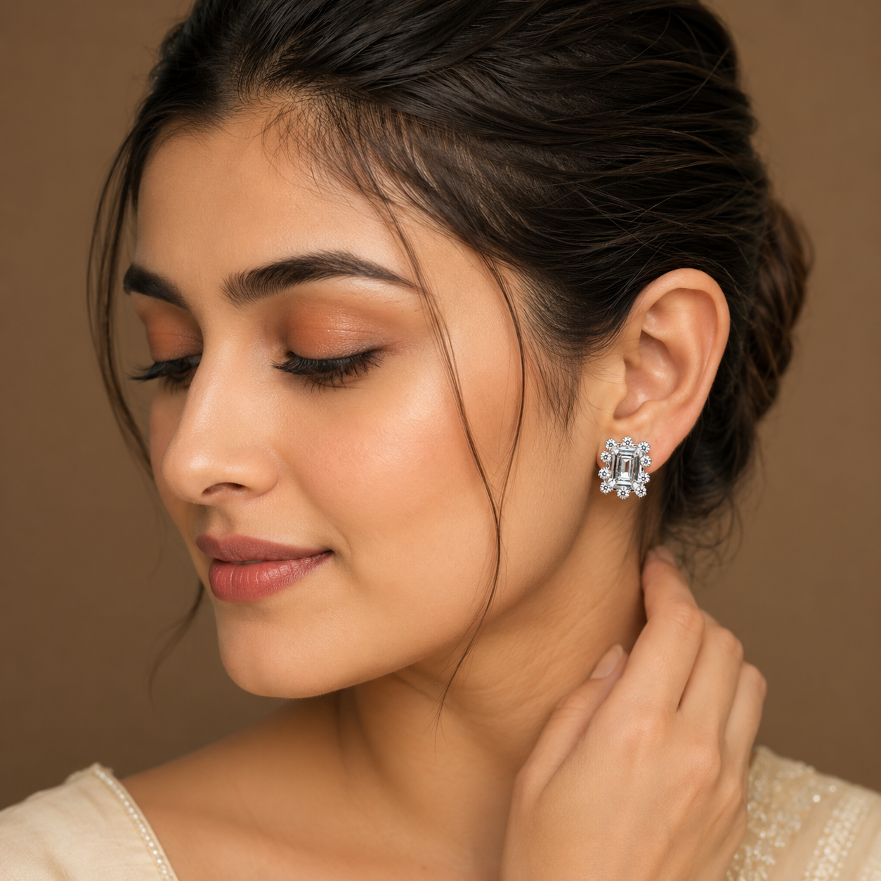 Model wearing Silver Emerald Cut Scalloped CZ Stud Earrings with rectangular centre stones and a sparkling scalloped halo