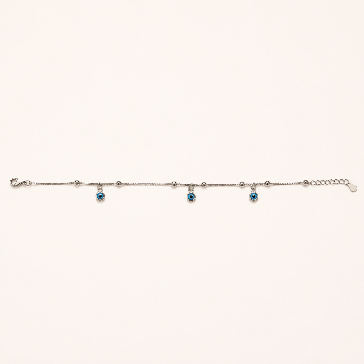 Silver evil eye anklet with a single blue charm