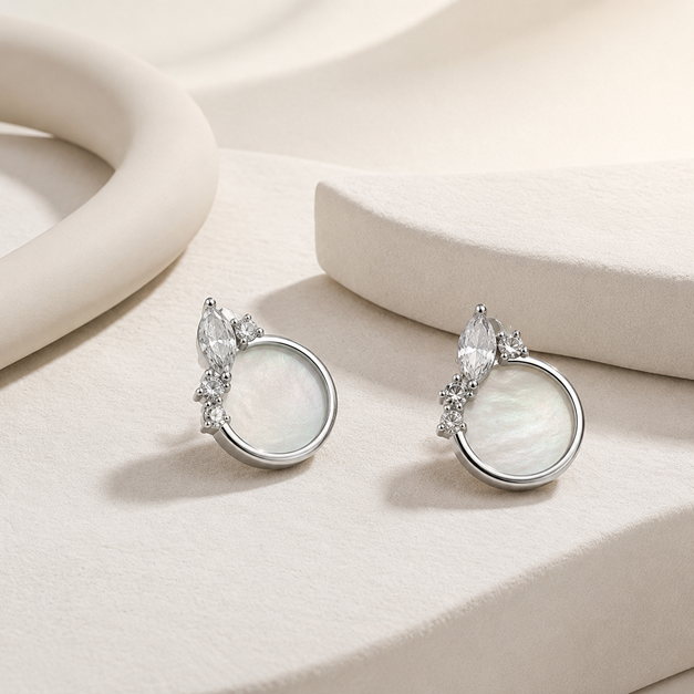 Pair of Silver Mother-of-Pearl Crystal Stud Earrings (Marquise CZ Accent) displayed on a neutral surface with marquise CZ accents above the round mother-of-pearl discs