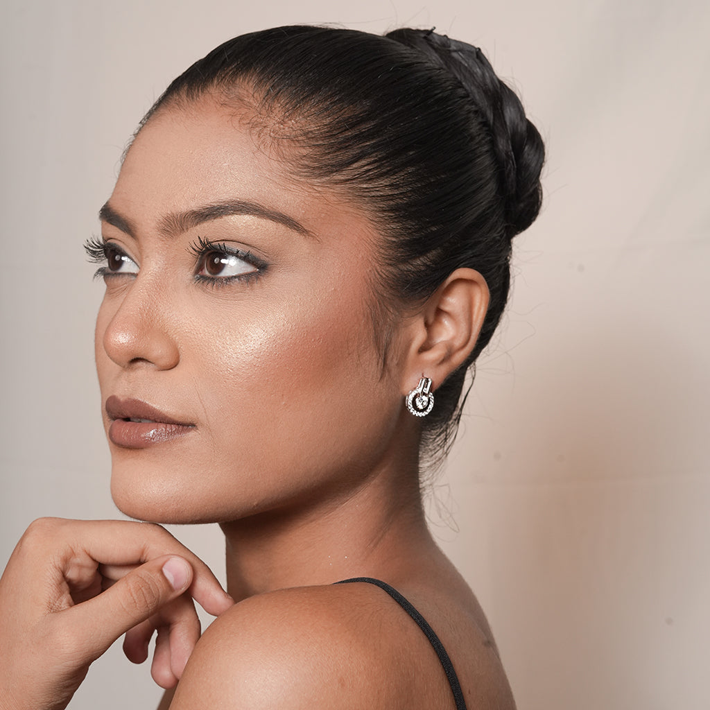 Model wearing Silver Open Circle Halo Stud Earrings (Round CZ Centre) with a sparkling round centre and open halo design