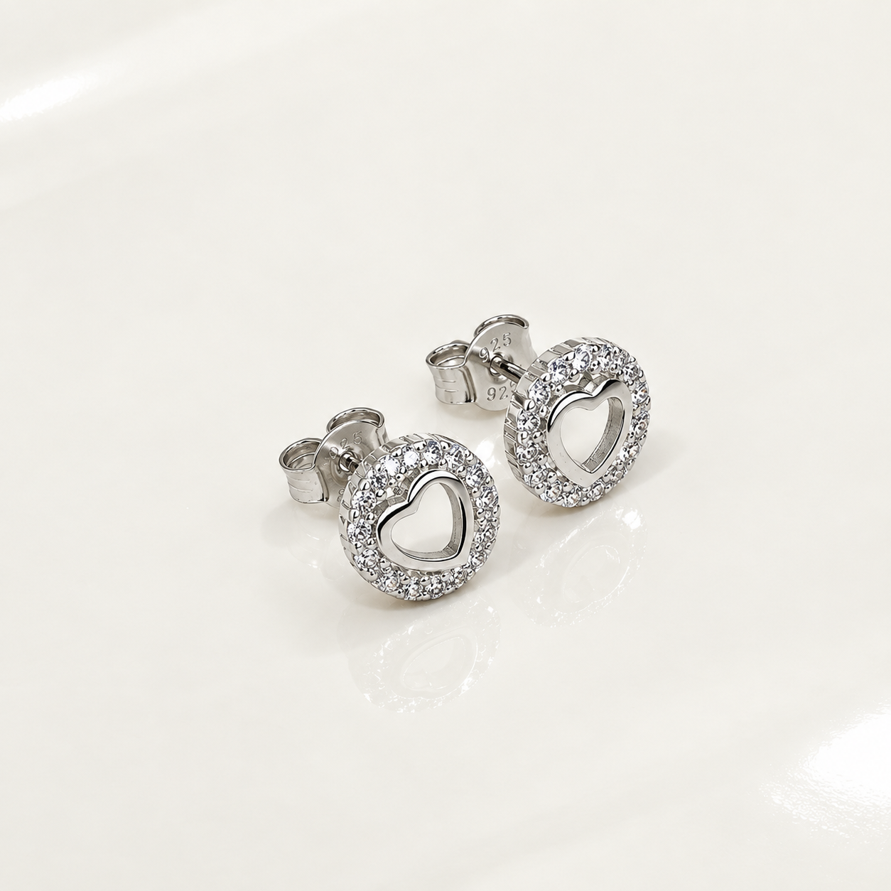 Angled side view of Silver Open Heart Round Halo Stud Earrings with push-back posts