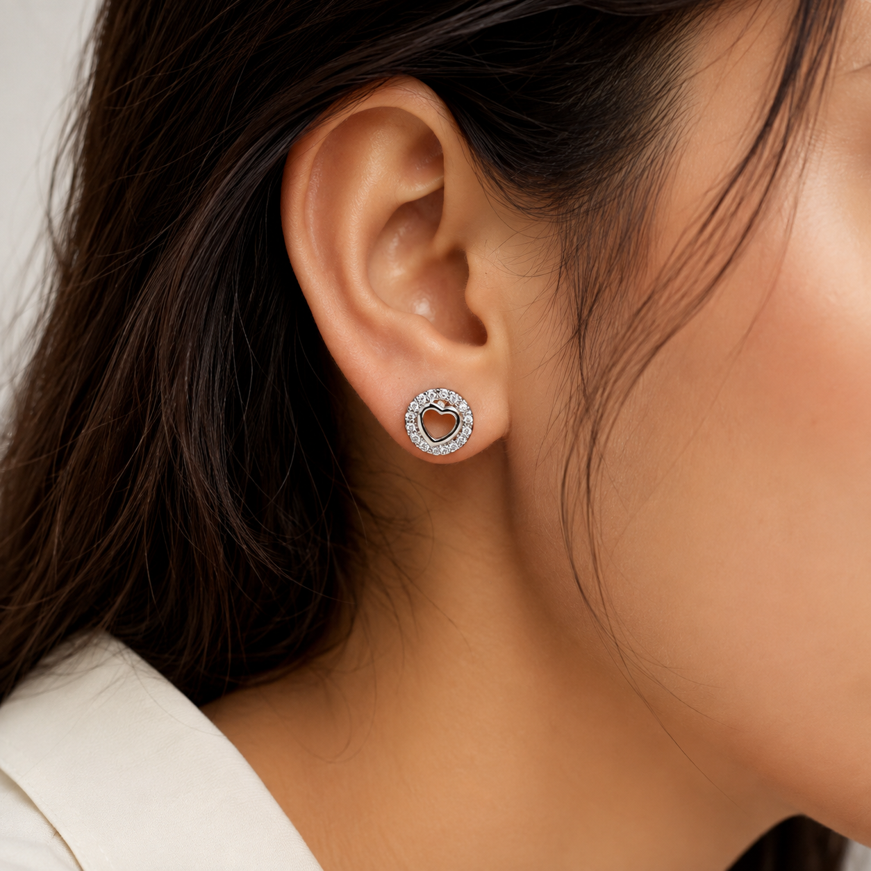 Close-up of a model wearing Silver Open Heart Round Halo Stud Earrings on the ear