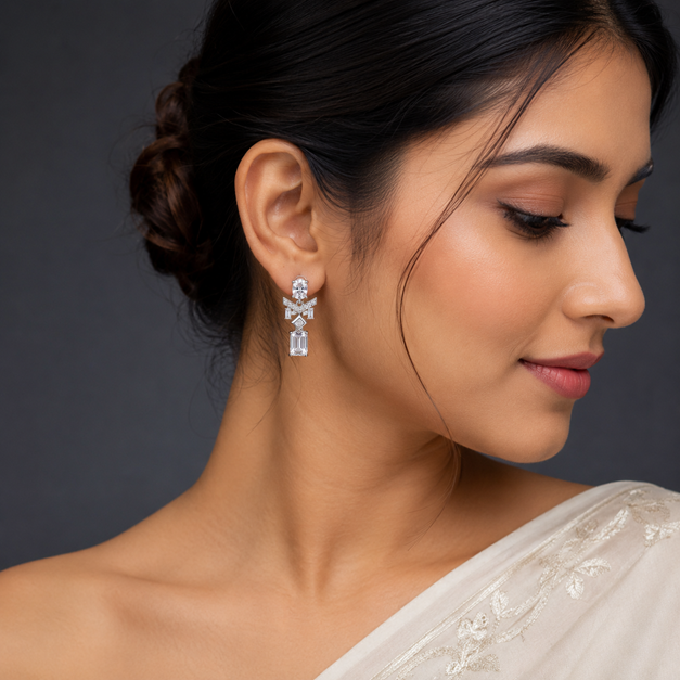 Model wearing Silver Oval Baguette CZ Emerald Cut Drop Earrings with a layered geometric drop design