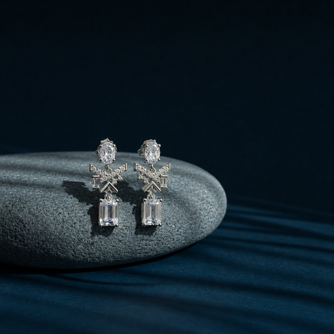 Silver Oval Baguette CZ Emerald Cut Drop Earrings displayed on a stone prop, showing oval, baguette and emerald-cut CZ details