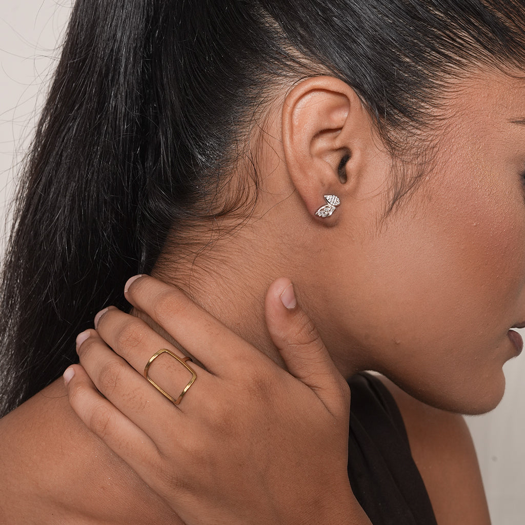 Close-up of Silver Pave Double Leaf Stud Earrings with baguette-cut and round stones set across the twin leaf design
