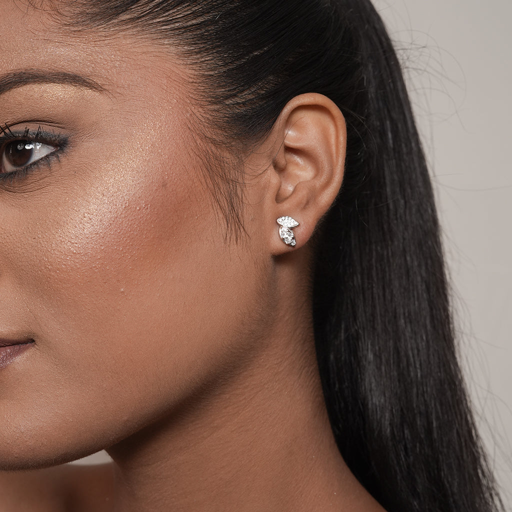 Model wearing Silver Pave Double Leaf Stud Earrings featuring sparkling baguette and round stone accents