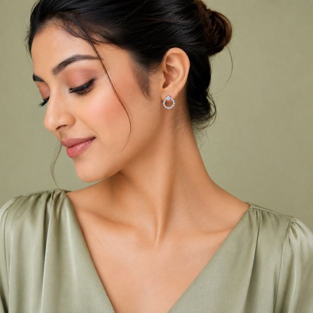 Model wearing Silver Pear CZ Open Circle Stud Earrings with the pear-shaped top detail and circular CZ halo design