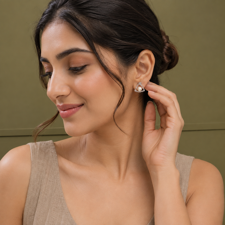 Model wearing Silver Pearl Baguette Triangle Stud Earrings with a pearl centre and sparkling triangular frame