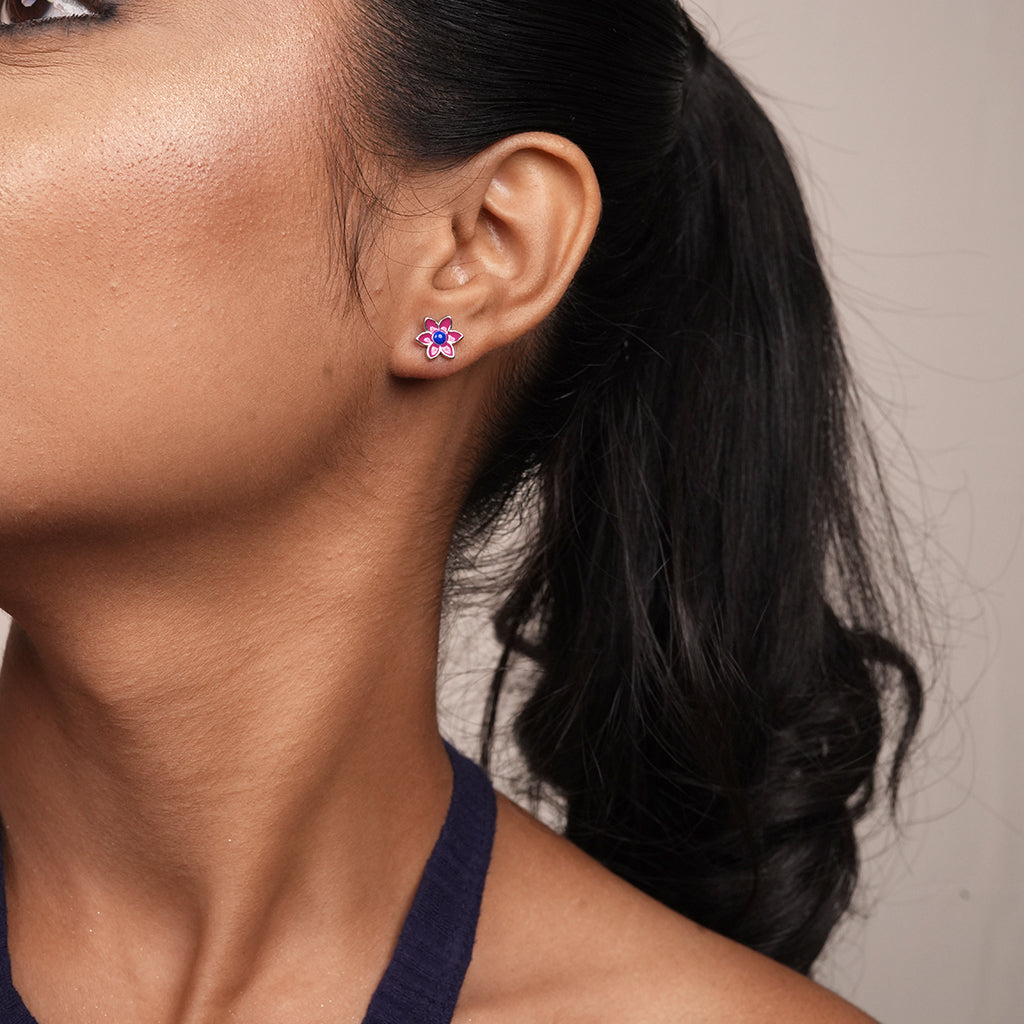 Close-up of Silver Purple Enamel Floral Stud Earrings showing purple enamel petals with a blue enamel centre