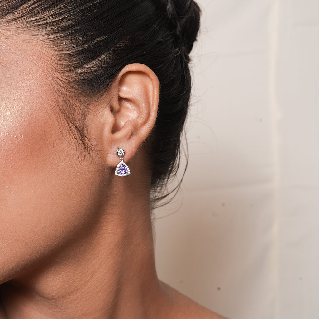 Close-up of Silver Purple Trillion Drop Earrings (Halo) showing a purple trillion-cut centre stone surrounded by a sparkling halo