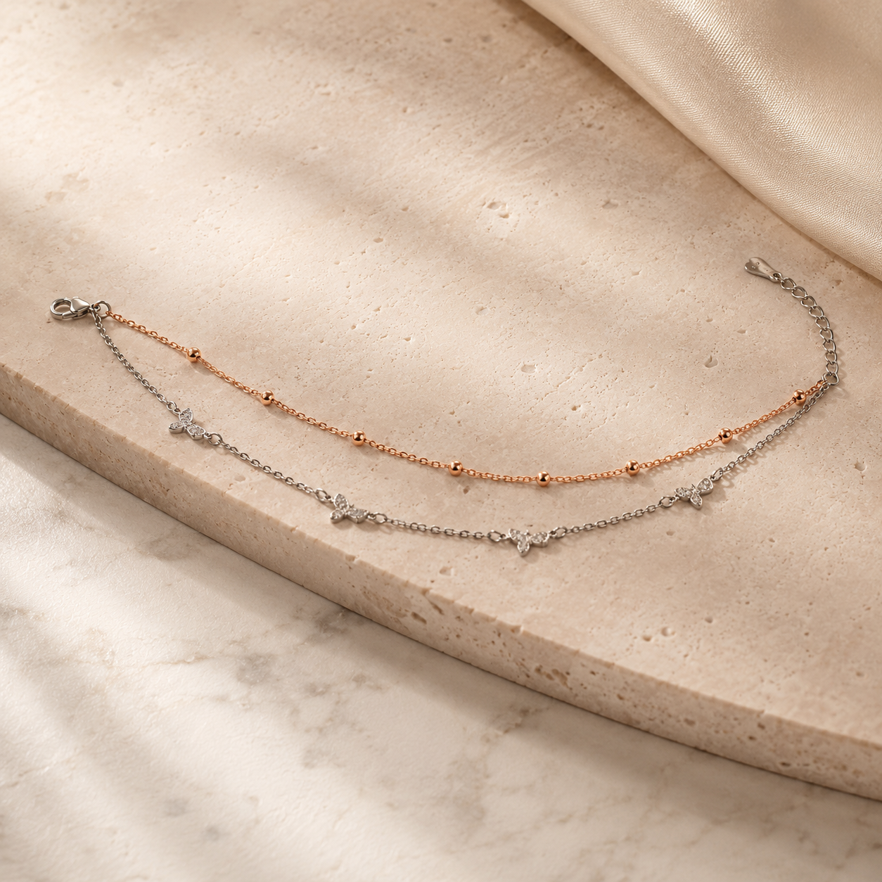 Hanging butterfly charms on an adjustable silver anklet