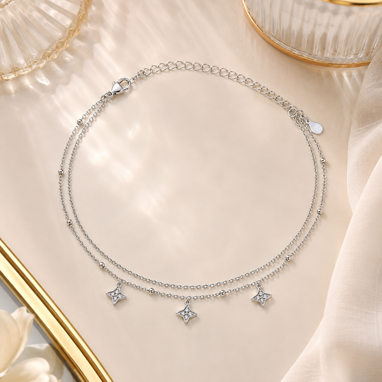 Repeating CZ star charms on a delicate silver anklet
