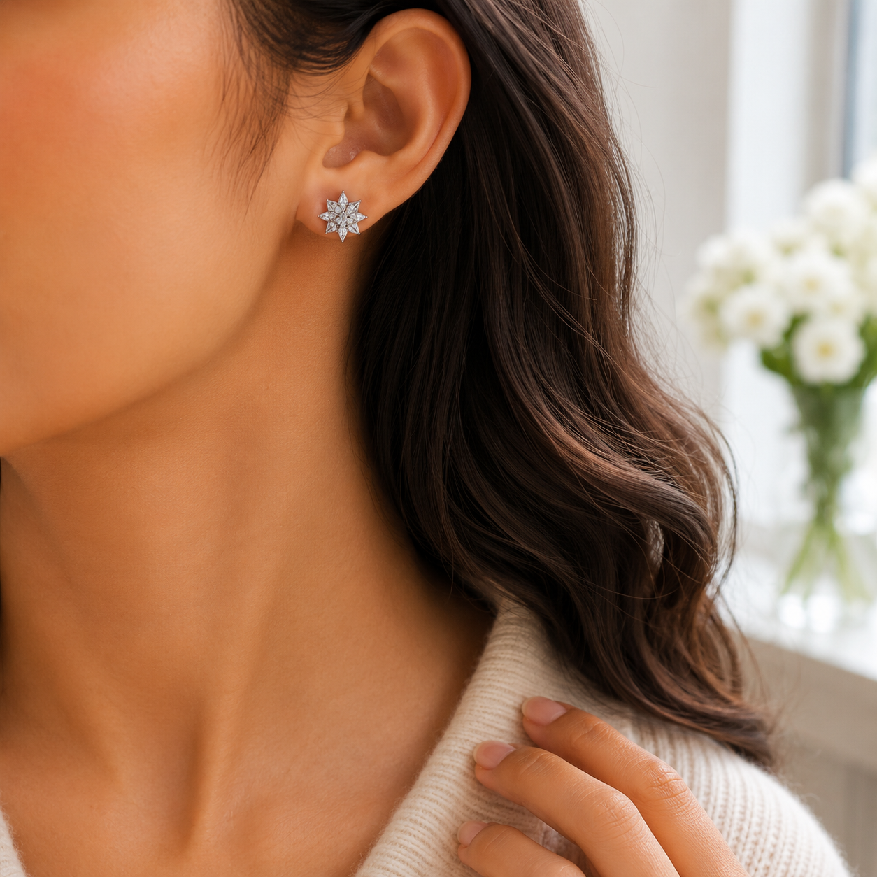 Close-up profile of a woman wearing the silver starburst cluster stud earring