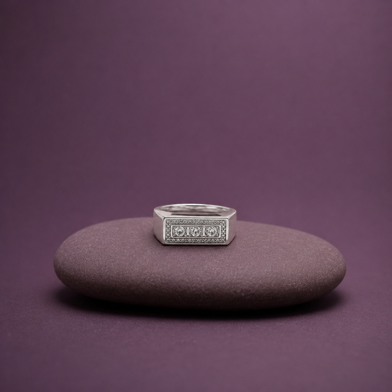 Three CZ stones spaced across a silver band ring