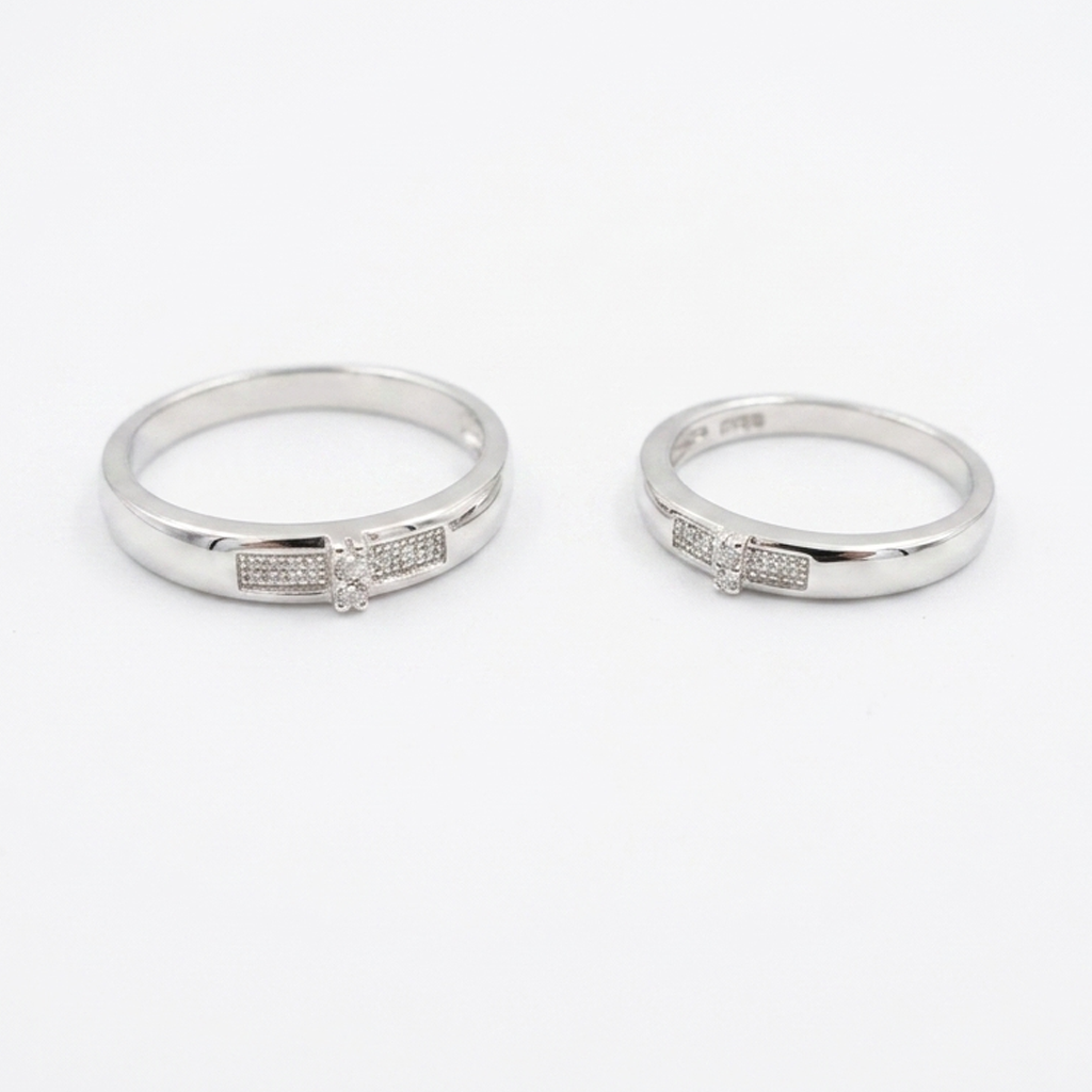 A pair of Sterling Silver Embellished Promise Couple Rings with embellished rectangular centerpieces on a clean white background. 