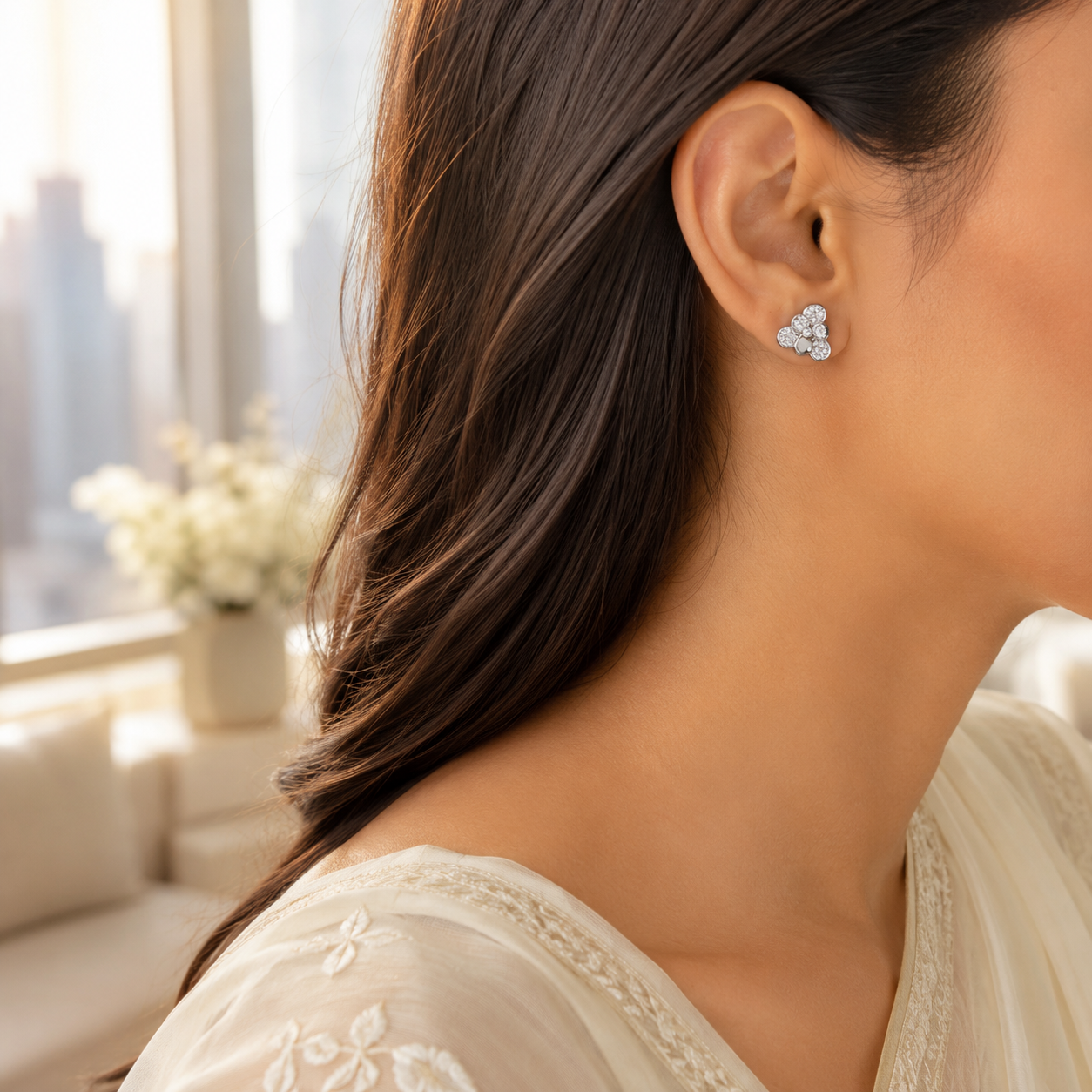 Side profile of a woman wearing the Sterling Silver Floral Cluster Stud Earring in a bright, modern setting