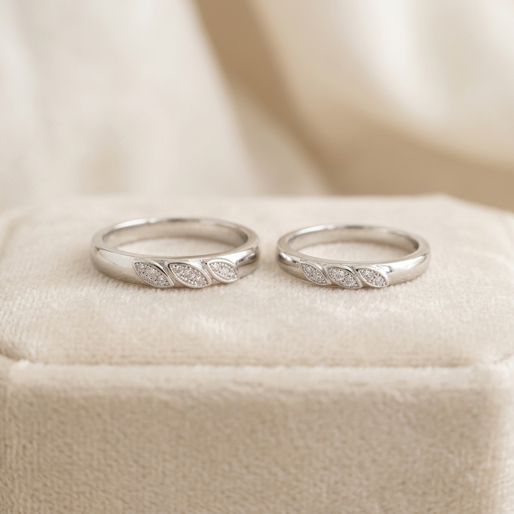 Sterling Silver Triple Leaf Pave Couple Bands resting on a beige velvet ring box