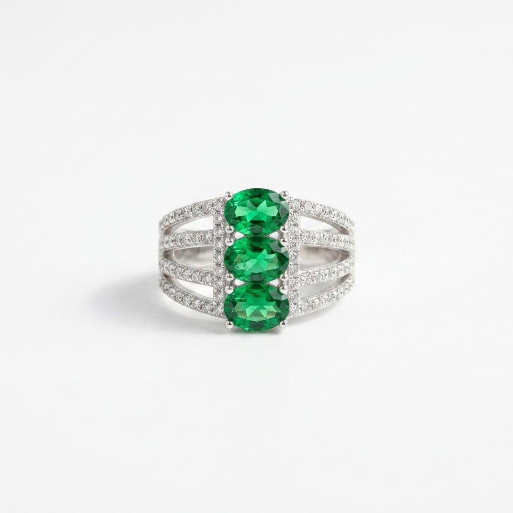 Close-up of a Triple Oval Green Gemstone Silver Statement Ring with three oval green gemstones and pave clear stones on a white background 