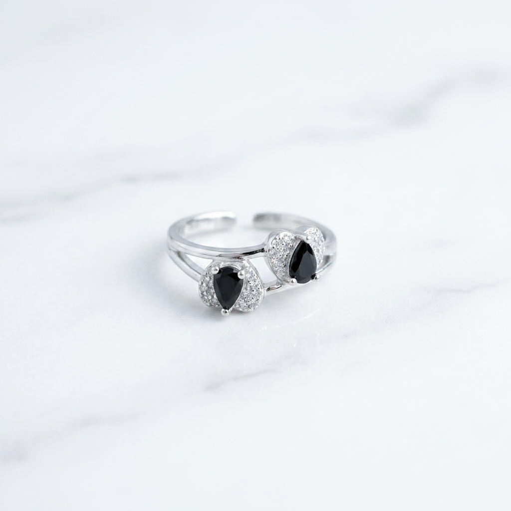 Detailed view of the Twin Teardrop Black Stone Adjustable Silver Ring featuring double black teardrops with crystal halos on a white background
