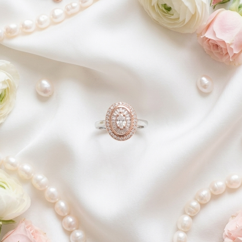 Vintage Two-Tone Vintage Oval Halo Ring styled romantically on draped white silk fabric, beautifully surrounded by loose white pearls and soft pink roses.