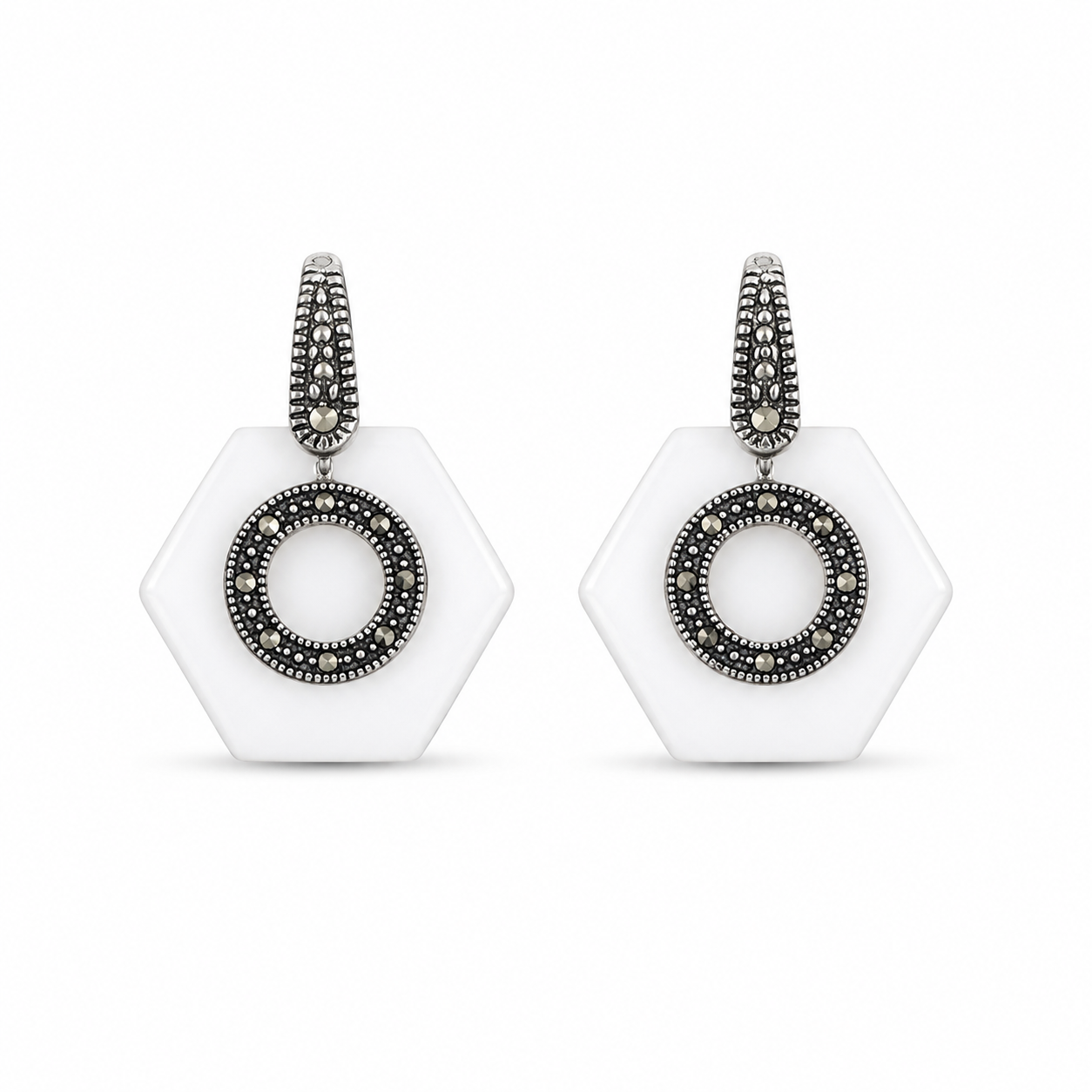 Front view of the White Hexagon Oxidized Silver Statement Earrings showing the circular metallic detail against the white base.